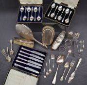 A silver backed part dressing table set comprising a hand mirror and two clothes brushes together