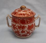 A Chinese porcelain twin handled vase and cover decorated with gilt highlighted iron red flowers,