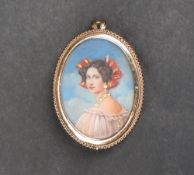 An 9ct gold portrait miniature pendant / brooch, depicting a lady wearing gem set jewellery,