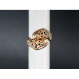 A 14ct yellow gold ring in the form of two leopards heads set with ruby eyes,