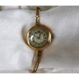 An 18ct yellow gold lady's wristwatch, with a mother of pearl dial and Arabic numerals,