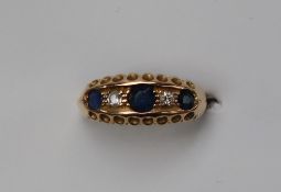 A sapphire and diamond line ring,