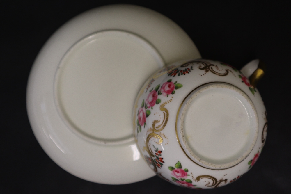 A Swansea porcelain tea cup and saucer painted with roses in a gilt garland border, 9. - Image 6 of 6