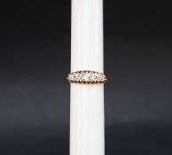 A five stone diamond ring set with graduated old round cut diamonds to a yellow metal setting and