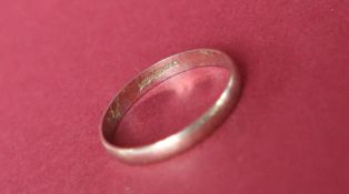 A 9ct white gold wedding band, size P, approximately 1.