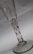 A 19th century wine glass with a tapering bowl and a diamond faceted stem on a spreading foot,