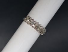 A diamond half eternity ring set with twelve brilliant cut diamonds and five baguette cut diamonds