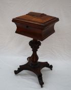 A Victorian rosewood teapoy, the hinged caddy top now enclosing a vacant lined interior,