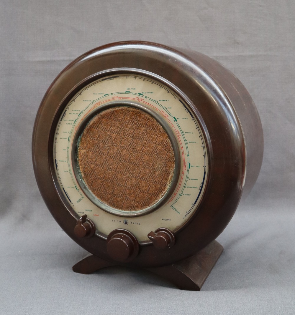 An Ekco type A22 radio with a circular bakelite case with three dials,