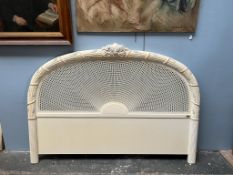 A King size bed head board decorated with leaves and flowers to a bergere panel, painted cream,