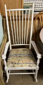 A white painted stick back rocking chair