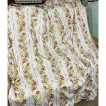 A pair of fringed cream, green and rose pattern curtains, pleated top 51" wide each,