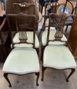 A set of four mahogany salon chairs with pad seats on cabriole legs and pad feet