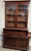 A Victorian mahogany secretaire bookcase, the moulded cornice above a pair of glazed doors,