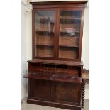 A Victorian mahogany secretaire bookcase, the moulded cornice above a pair of glazed doors,