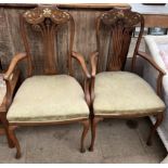 A pair of Edwardian salon chairs the scrolling back inlaid with mother of pearl flowers and leaves