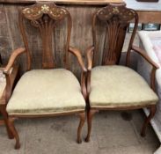 A pair of Edwardian salon chairs the scrolling back inlaid with mother of pearl flowers and leaves