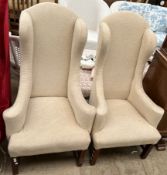 A pair of George III style wing back armchairs of small proportions on square legs