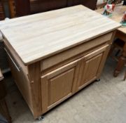 A pie kitchen island, the rectangular top above pull out chopping boards,