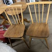 A pair of Ercol stick back kitchen chairs