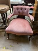 An Edwardian upholstered horseshoe shaped chair with button back upholstery,