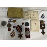 A Queen Mary tin together with two World War II medals,