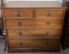 An Edwardian walnut chest with a rectangular top above two short and three long graduated drawers
