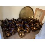 A collection of copper lustre jugs, teapot and a brass tray,