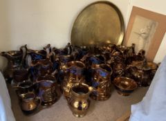 A collection of copper lustre jugs, teapot and a brass tray,