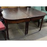A 19th century mahogany dining table with two D ends on ring turned legs