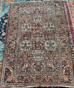 An Oriental hand woven rug with a central field of panels of flowers and leaves to multiple guard