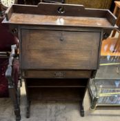 A 20th century oak bureau with a three quarter raised back and sloping fall enclosing pigeon holes