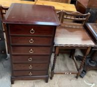 A tall stag chest of drawers together with an oak occasional table