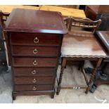 A tall stag chest of drawers together with an oak occasional table