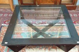 A black ash and glass coffee table of square form