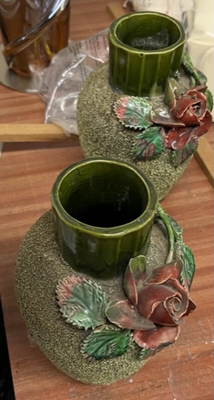 A pair of green rose encrusted pottery vase