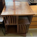 A mahogany revolving bookcase with central fan inlay