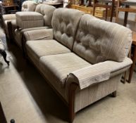 A modern upholstered and teak four piece suite comprising a three seater settee,
