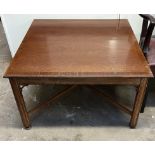 A reproduction mahogany coffee table of square form on square legs