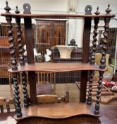 Victorian hanging shelves with serpentine fronts on barley twist columns