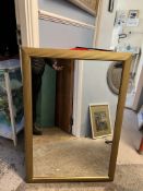 A gilt wall mirror with a reeded edge