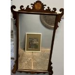 A George III style mahogany wall mirror with fan inlay,