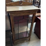 A 20th century oak display cabinet with an arched upstand glazed door and sides on square legs