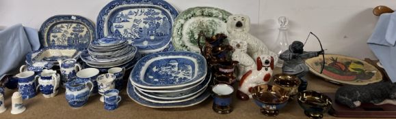 A collection of blue and white willow pattern meat plates together with other blue and white plates,