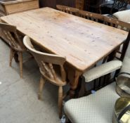 A pine kitchen table with turned and reeded legs together with a pair of kitchen chairs