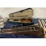 A Hawkes electroplated trombone within a leather case together with a child's violin,