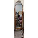 A 20th century mahogany cheval mirror with an arched top above long mirror plate supported on