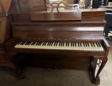 A Challen mahogany upright piano on leaf capped cabriole legs and claw and ball feet and casters