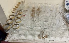 Gold rimmed wine glasses together with other wine glasses,