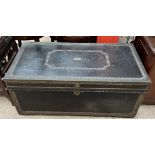 A leather and brass bound trunk, with studded decoration,